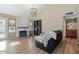 Living room with hardwood floors, fireplace, and a view of the kitchen at 2235 E Lakecrest Dr, Gilbert, AZ 85234
