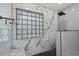 Shower with marble tile, glass block window, and pebble floor at 2235 E Lakecrest Dr, Gilbert, AZ 85234
