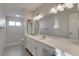 Bathroom with double vanity, large mirror, and tiled shower at 2534 S Grandview Ave, Tempe, AZ 85282