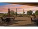 Evening view of a backyard patio with seating and desert landscape at 28728 N 129Th Ln, Peoria, AZ 85383