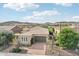 Single-story home with a two-car garage and desert landscaping at 28728 N 129Th Ln, Peoria, AZ 85383