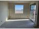 Bedroom with a large window and sliding glass door, providing natural light and outdoor access at 7631 W Tether Trl, Peoria, AZ 85383