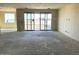 Spacious living room featuring sliding glass doors and a large window offering abundant natural light at 7631 W Tether Trl, Peoria, AZ 85383