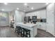 Modern kitchen featuring white cabinets, an island, and stainless steel appliances at 1078 S 151St Ln, Goodyear, AZ 85338