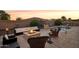 Inviting backyard with a fire pit, pool, and outdoor seating at 12866 S 183Rd Ave, Goodyear, AZ 85338