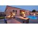 Outdoor kitchen, pool, and patio with fire features at 12866 S 183Rd Ave, Goodyear, AZ 85338