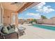 Relaxing backyard oasis with a sparkling pool and patio furniture at 12866 S 183Rd Ave, Goodyear, AZ 85338
