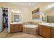 Large bathroom with double sinks, a soaking tub, and a walk-in shower at 12866 S 183Rd Ave, Goodyear, AZ 85338