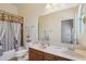 Bathroom with double vanity, shower, and decorative elements at 12866 S 183Rd Ave, Goodyear, AZ 85338