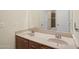 Double vanity bathroom with granite countertop and modern fixtures at 12866 S 183Rd Ave, Goodyear, AZ 85338