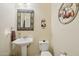 Small bathroom with pedestal sink and decorative accents at 12866 S 183Rd Ave, Goodyear, AZ 85338