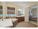 Main bathroom with double sinks and a view into the bedroom at 12866 S 183Rd Ave, Goodyear, AZ 85338