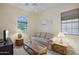 Light and airy bedroom with a couch and TV at 12866 S 183Rd Ave, Goodyear, AZ 85338