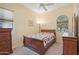 Cozy bedroom with wooden furniture and window coverings at 12866 S 183Rd Ave, Goodyear, AZ 85338