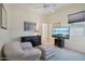 Bedroom with comfy seating and large TV at 12866 S 183Rd Ave, Goodyear, AZ 85338