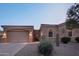 Tan stucco house with a two-car garage and desert landscaping at 12866 S 183Rd Ave, Goodyear, AZ 85338