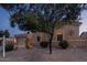 Tan stucco house with a two-car garage and desert landscaping at 12866 S 183Rd Ave, Goodyear, AZ 85338