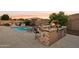 Outdoor kitchen with grill, sink, and bar seating at 12866 S 183Rd Ave, Goodyear, AZ 85338