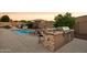 Outdoor kitchen with grill, sink, and bar seating at 12866 S 183Rd Ave, Goodyear, AZ 85338