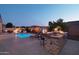 Outdoor kitchen and pool with lounge chairs at 12866 S 183Rd Ave, Goodyear, AZ 85338