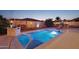 Inviting backyard pool with built-in spa and outdoor kitchen at 12866 S 183Rd Ave, Goodyear, AZ 85338