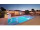 Inviting backyard pool with built-in spa and outdoor kitchen at 12866 S 183Rd Ave, Goodyear, AZ 85338