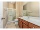 Bathroom with walk-in shower and wood vanity at 21438 S 194Th St, Queen Creek, AZ 85142