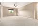 Bright bedroom with neutral carpeting and a ceiling fan at 21438 S 194Th St, Queen Creek, AZ 85142