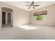 Spacious bedroom with carpeting and access to other rooms at 21438 S 194Th St, Queen Creek, AZ 85142