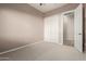 Well-lit bedroom with double doors leading to a private bathroom at 21438 S 194Th St, Queen Creek, AZ 85142