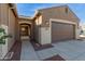 Single-story home with a two-car garage and gated entryway at 21438 S 194Th St, Queen Creek, AZ 85142