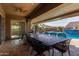 Relaxing covered patio with outdoor dining and pool access at 21438 S 194Th St, Queen Creek, AZ 85142