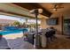Covered patio with outdoor dining and pool view at 21438 S 194Th St, Queen Creek, AZ 85142