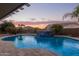 Curving pool with a stone water feature at 21438 S 194Th St, Queen Creek, AZ 85142
