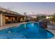 Inviting backyard pool with stone accents and patio seating at 21438 S 194Th St, Queen Creek, AZ 85142