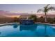 Relaxing kidney-shaped pool and a stone water feature at 21438 S 194Th St, Queen Creek, AZ 85142