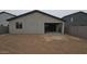 Back exterior view of the home, showcasing the empty backyard and block fencing at 32181 N Saddlehorn Dr, San Tan Valley, AZ 85140