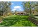 Expansive backyard with lush lawn, mature trees, and patio seating, perfect for outdoor entertaining at 6322 E Turquoise Ave, Paradise Valley, AZ 85253