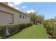 Expansive backyard featuring artificial turf, mature trees, and a view of the home's exterior at 6322 E Turquoise Ave, Paradise Valley, AZ 85253