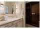 Elegant bathroom features custom vanity, granite countertop and opens into an expansive dark wood wardrobe at 6322 E Turquoise Ave, Paradise Valley, AZ 85253