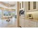 Bright bathroom with a soaking tub, chandelier, and built-in Miele coffee system at 6322 E Turquoise Ave, Paradise Valley, AZ 85253