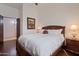 This bedroom features a dark wood bed frame, hardwood floors, and an open door at 6322 E Turquoise Ave, Paradise Valley, AZ 85253