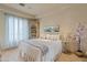 Bright bedroom with a large window, tile floor, decorative tree, accent pillows, and beautiful decor at 6322 E Turquoise Ave, Paradise Valley, AZ 85253