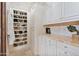 Well-organized closet with shoe shelves, cabinets, and a marble countertop at 6322 E Turquoise Ave, Paradise Valley, AZ 85253