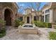 Charming courtyard with stone fountain, mature trees, and architectural details at 6322 E Turquoise Ave, Paradise Valley, AZ 85253