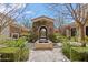 Tranquil courtyard with stone fountain, arched entryway, and serene landscaping at 6322 E Turquoise Ave, Paradise Valley, AZ 85253