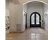 The entryway showcases an arched wrought iron front door and neutral tile flooring at 6322 E Turquoise Ave, Paradise Valley, AZ 85253