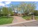 Beautiful home with mature trees, well-manicured landscaping, and a brick driveway at 6322 E Turquoise Ave, Paradise Valley, AZ 85253