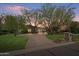 Street view of beautiful home with mature trees, an expansive brick driveway and lush landscaping at 6322 E Turquoise Ave, Paradise Valley, AZ 85253