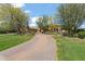 Expansive front yard features a circular driveway, mature trees, and well-manicured lawn at 6322 E Turquoise Ave, Paradise Valley, AZ 85253